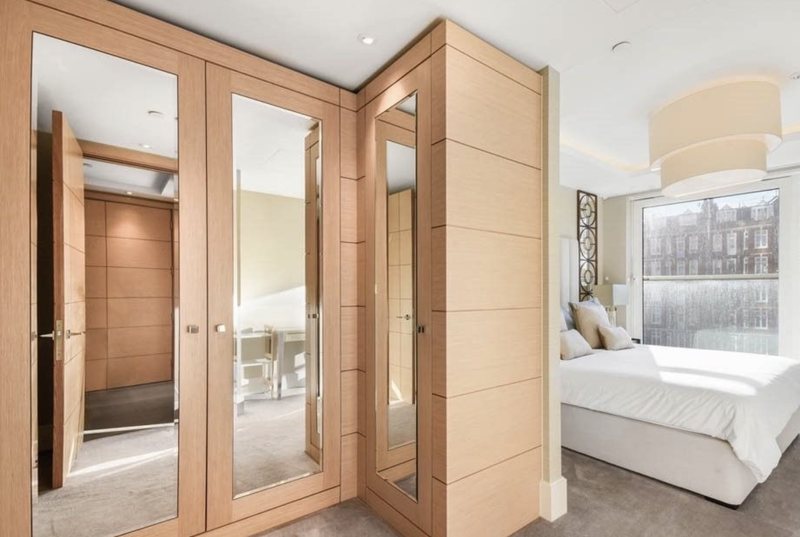 Bedroom with mirrored wardrobe doors