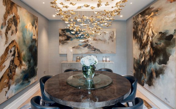 Dining area beneath a gilded chandelier