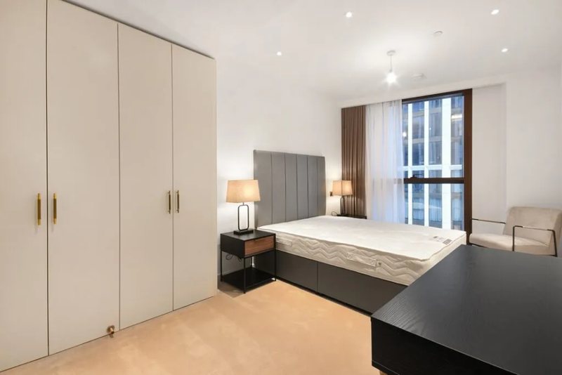 Bedroom with fitted wardrobes and desk