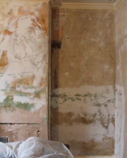 Interior wall stripped back to bare plaster during works