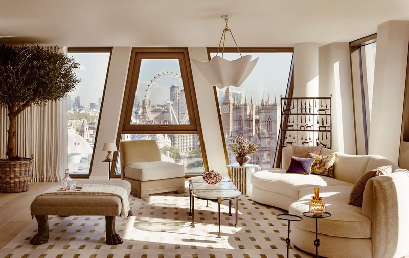 Bright living room with angled windows looking out to the London Eye and the Palace of Westminster