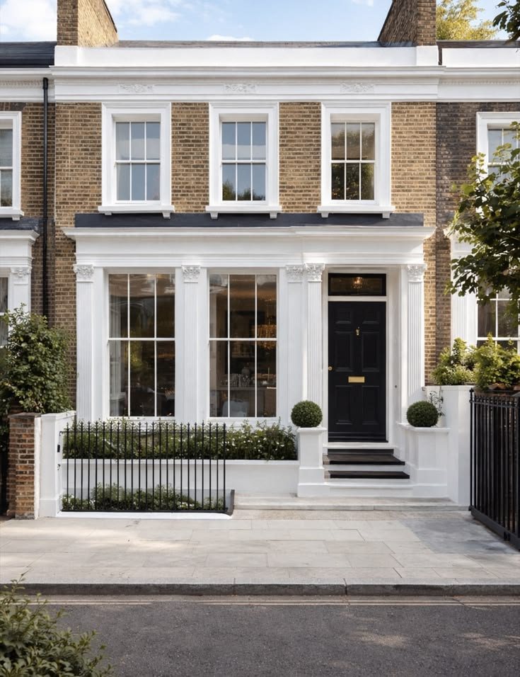 London brick townhouse with a white stucco ground floor and black front door