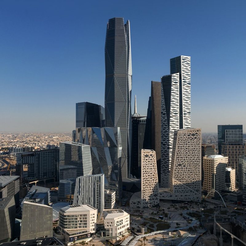 Modern city skyline in Saudi Arabia with angular towers at sunset